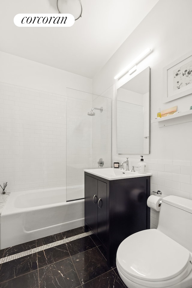96 Rockwell Pl Unit 11C, New York City, NY 11217 - full bathroom with toilet, marble finish floors, vanity, shower / tub combination, and tile walls
