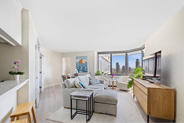 415 E 37th St Unit 31D, New York City, NY 10016 - living room with light wood-style floors and baseboards