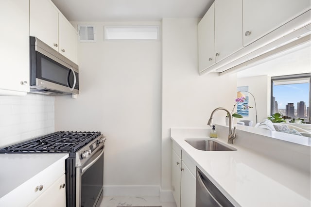 415 E 37th St Unit 31D, New York City, NY 10016 - kitchen featuring stainless steel appliances, a sink, tasteful backsplash, and light countertops