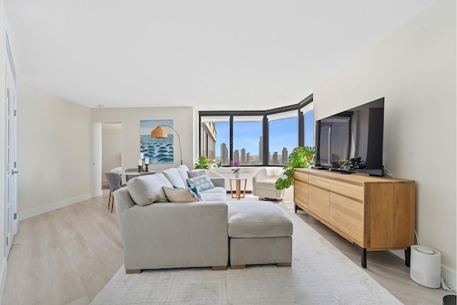 415 E 37th St Unit 31D, New York City, NY 10016 - living area featuring light wood-style floors and baseboards