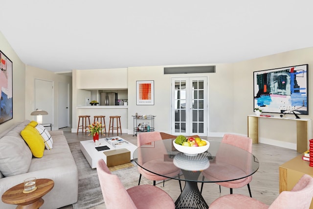 415 E 37th St Unit 31D, New York City, NY 10016 - living room featuring wood finished floors, baseboards, and french doors