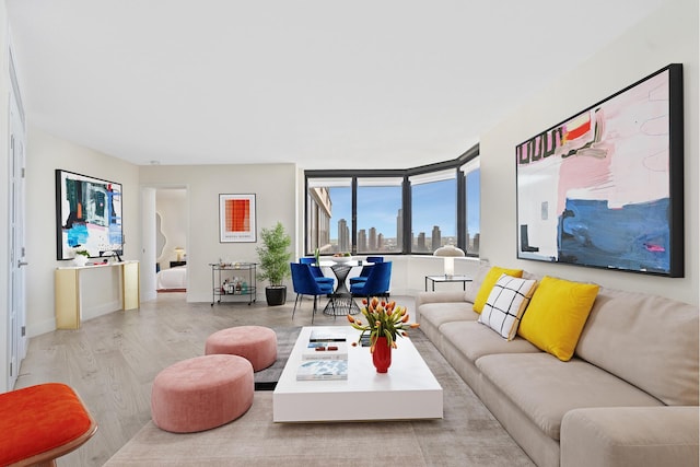 415 E 37th St Unit 31D, New York City, NY 10016 - living area featuring wood finished floors, a view of skyline, and baseboards