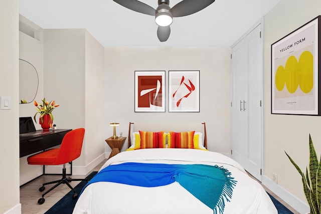 415 E 37th St Unit 31D, New York City, NY 10016 - bedroom with baseboards, wood finished floors, a desk, and ceiling fan