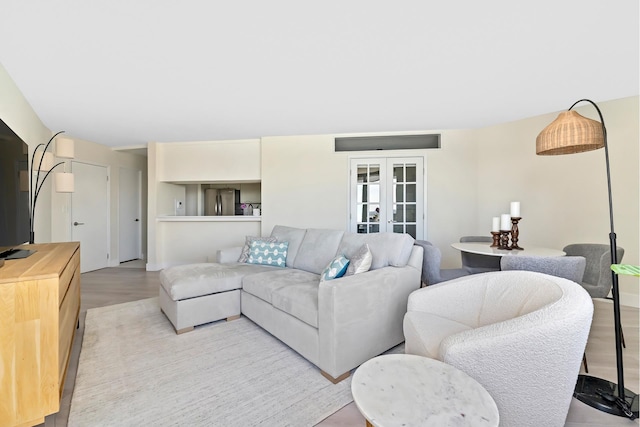 415 E 37th St Unit 31D, New York City, NY 10016 - living area with french doors and light wood-style flooring