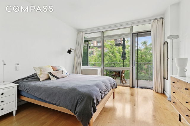 425 E 13th St Unit 5G, New York City, NY 10009 - bedroom with access to exterior and light wood-style floors