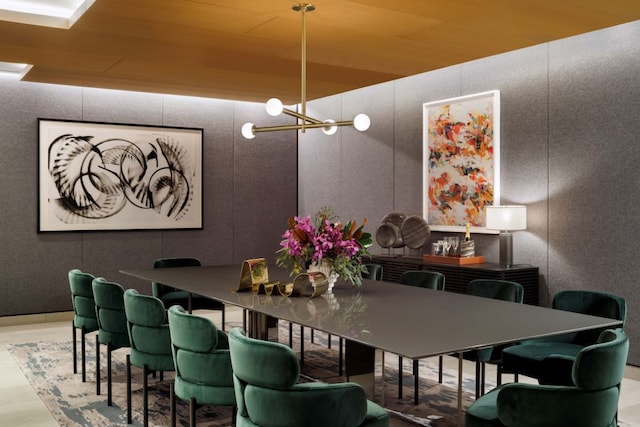dining room with a chandelier and a decorative wall