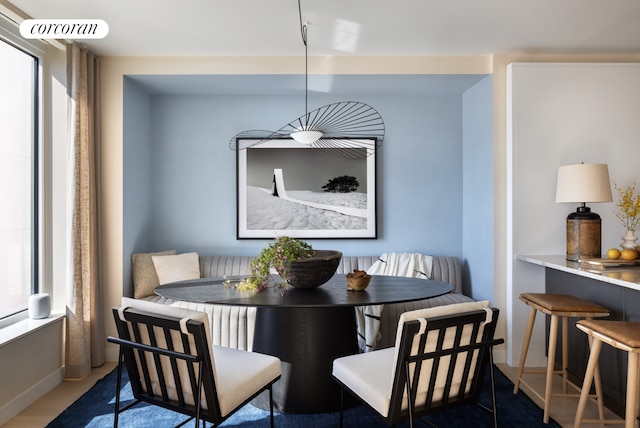 dining area featuring breakfast area and baseboards