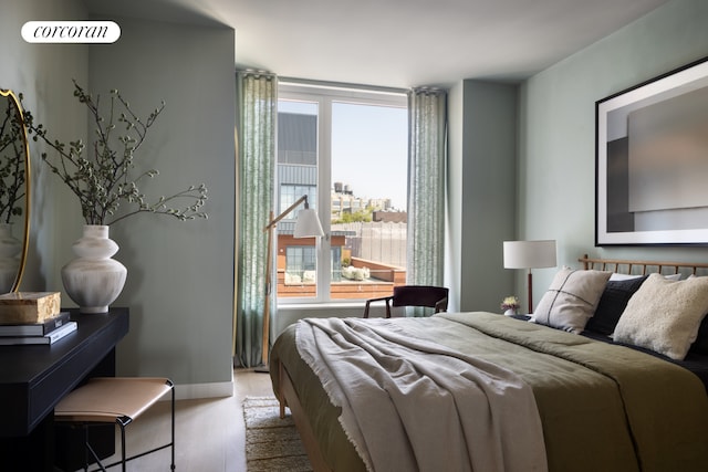 bedroom with wood finished floors and baseboards