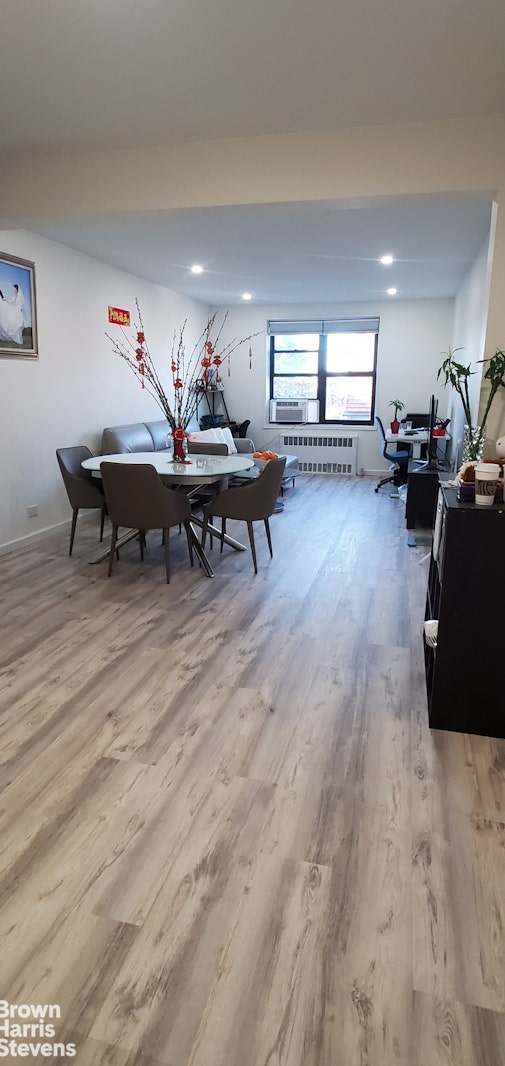 dining room with wood finished floors, radiator heating unit, a desk, recessed lighting, and baseboards