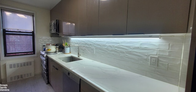 87-09 34th Ave Unit 3C, New York City, NY 11372 - kitchen with radiator, a sink, dishwashing machine, electric range oven, and stainless steel microwave