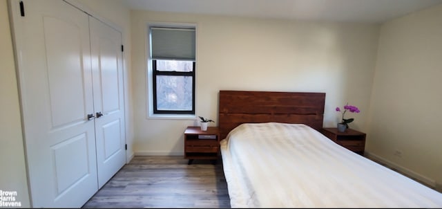 87-09 34th Ave Unit 3C, New York City, NY 11372 - bedroom featuring wood finished floors, a closet, and baseboards