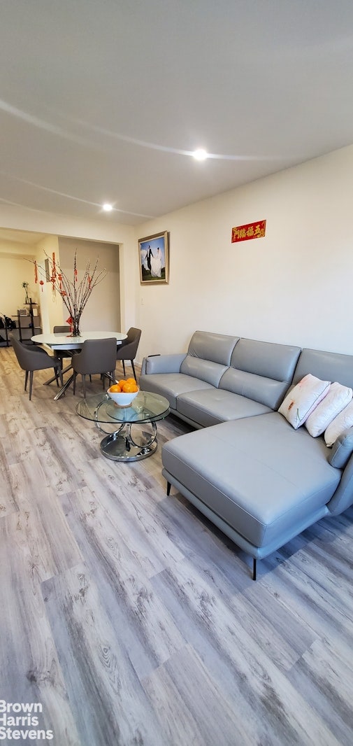 living room with wood finished floors and recessed lighting