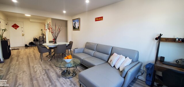 living room with light wood-style floors and recessed lighting