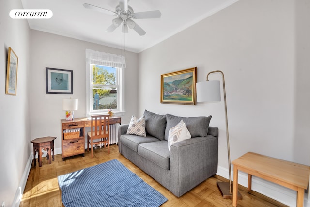 sitting room with baseboards, ceiling fan, radiator heating unit, and crown molding