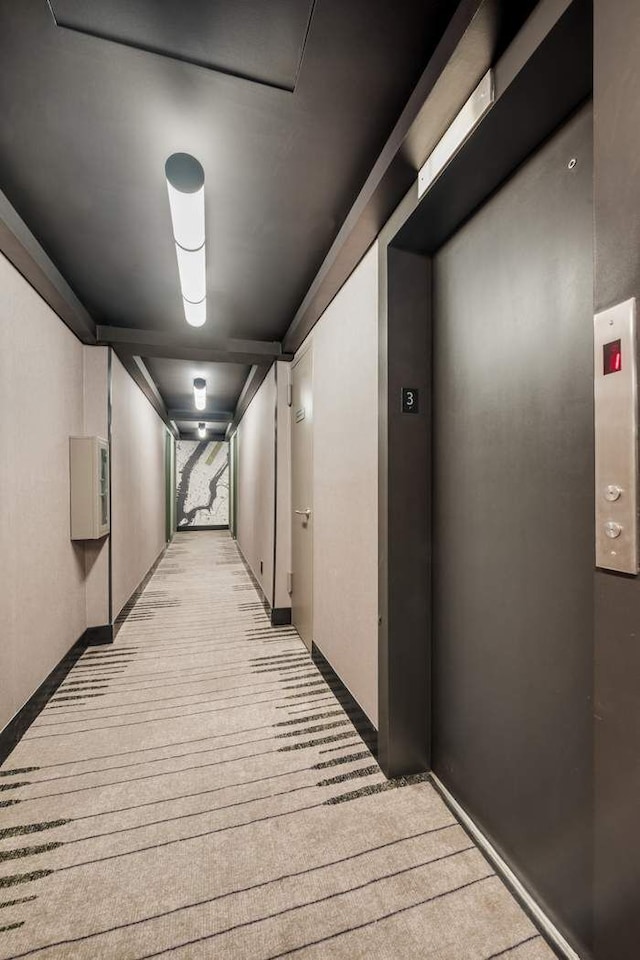 hall with elevator and baseboards