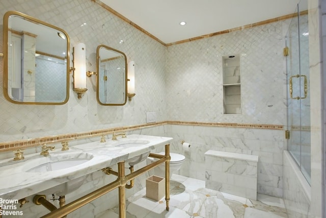 525 E 80th St Unit 7Bc, New York City, NY 10075 - bathroom with crown molding, a sink, toilet, enclosed tub / shower combo, and marble finish floors