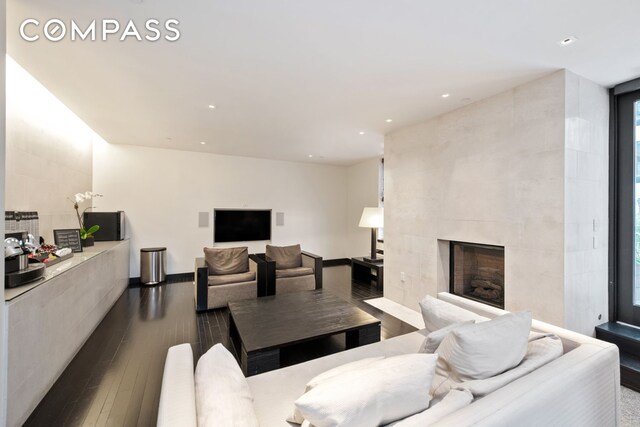 20 Pine St Unit 2905, New York City, NY 10005 - living area featuring dark wood finished floors, a tile fireplace, and recessed lighting