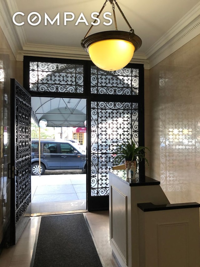 entryway featuring ornamental molding