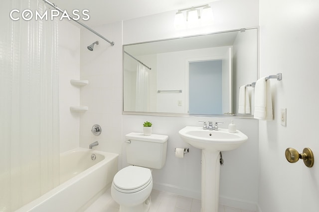 full bathroom with toilet, baseboards, shower / bathtub combination with curtain, tile patterned floors, and a sink