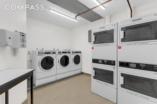 community laundry room featuring stacked washing machine and dryer and washing machine and clothes dryer