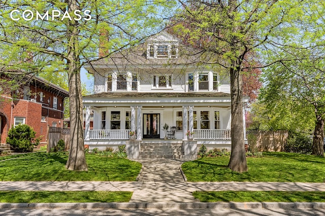 american foursquare style home featuring covered porch
