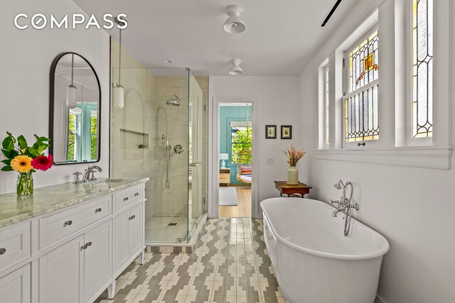 1221 Albemarle Rd, New York City, NY 11218 - full bathroom featuring a shower stall, a soaking tub, and vanity