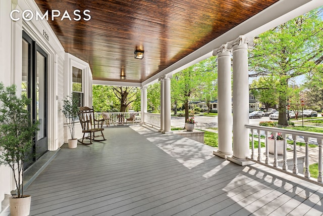 wooden terrace featuring covered porch