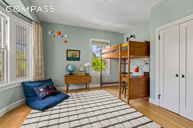 bedroom featuring wood finished floors and baseboards