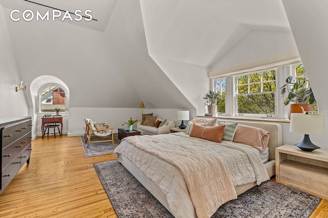 bedroom with vaulted ceiling and light wood-type flooring