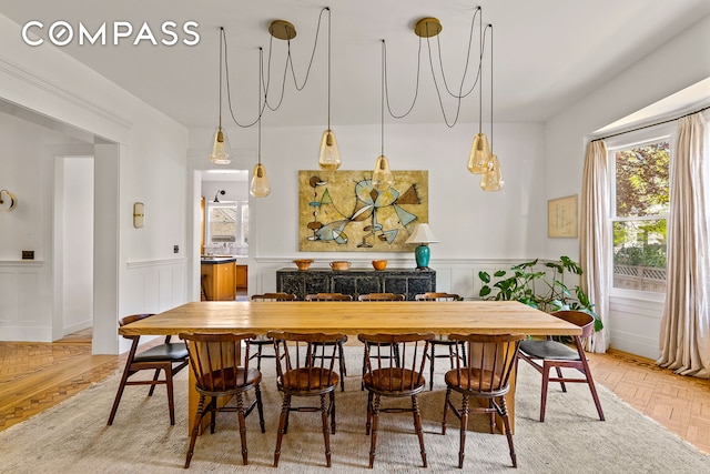 dining space featuring a wainscoted wall