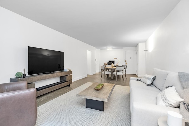77 W 55th St Unit 2H, New York City, NY 10019 - living room featuring wood finished floors and baseboards