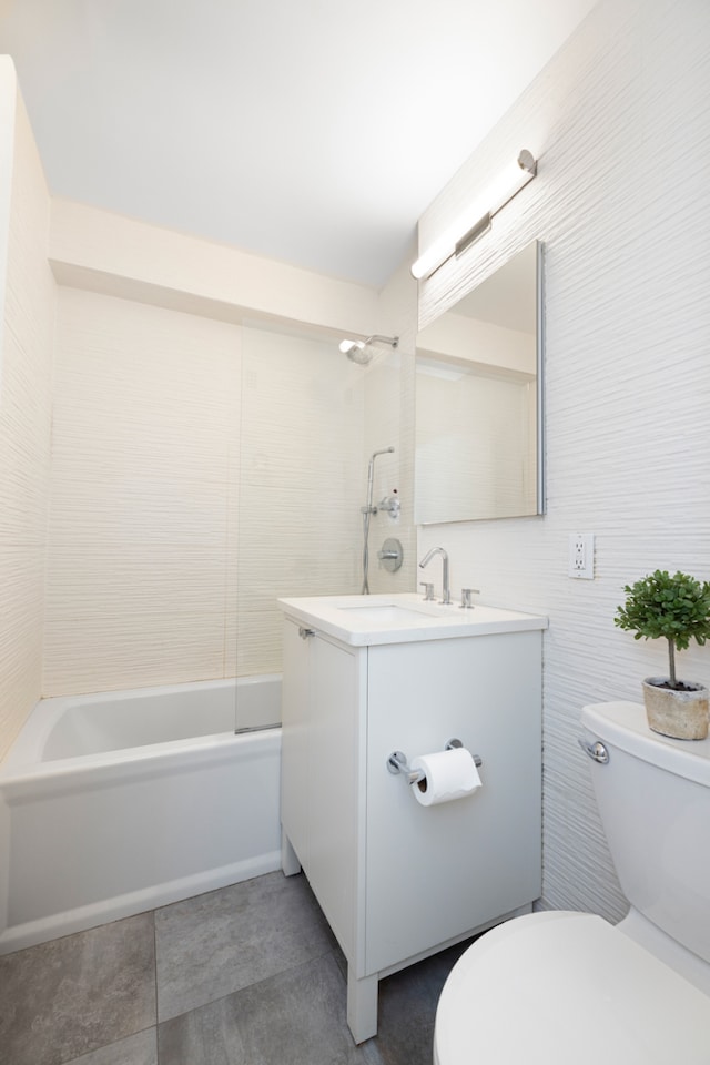 77 W 55th St Unit 2H, New York City, NY 10019 - full bathroom with vanity, washtub / shower combination, tile walls, and tile patterned flooring