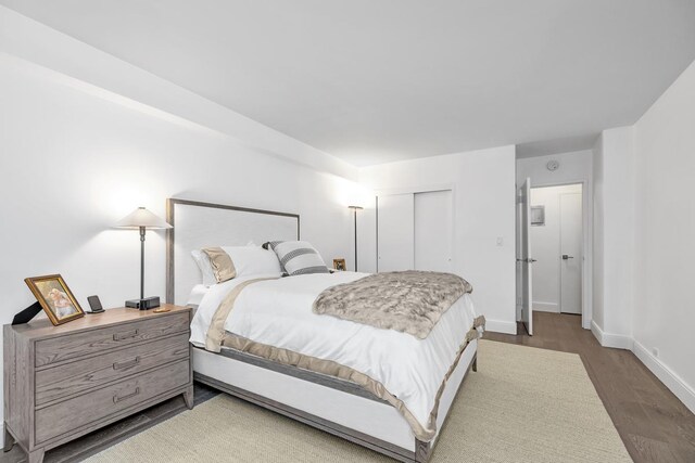 77 W 55th St Unit 2H, New York City, NY 10019 - bedroom with wood finished floors and a closet