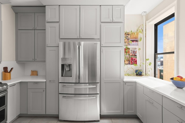 80 Winthrop St Unit 4C, New York City, NY 11225 - kitchen with appliances with stainless steel finishes, gray cabinetry, light countertops, and light tile patterned flooring