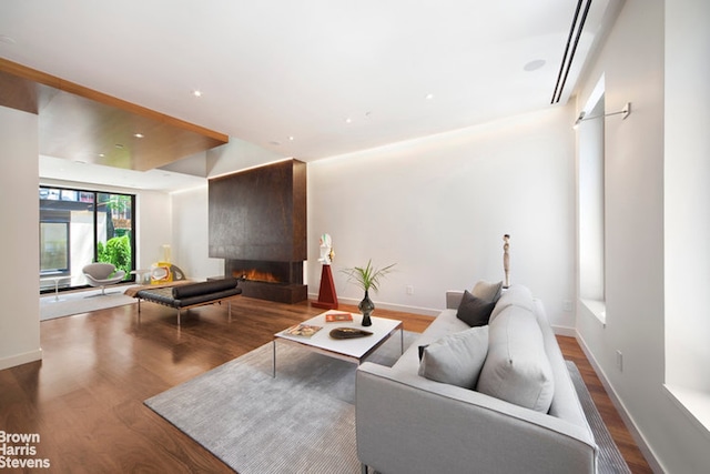251 E 61st St, New York City, NY 10065 - living room featuring a fireplace, wood finished floors, and baseboards
