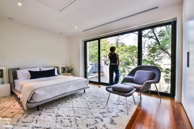 251 E 61st St, New York City, NY 10065 - bedroom with access to outside, multiple windows, wood finished floors, and attic access