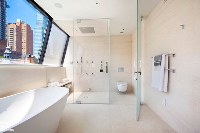 251 E 61st St, New York City, NY 10065 - full bathroom featuring a stall shower, a freestanding tub, a city view, and toilet