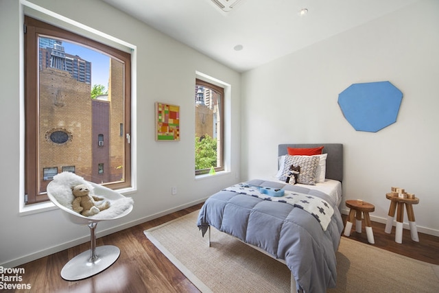 251 E 61st St, New York City, NY 10065 - bedroom with baseboards and wood finished floors