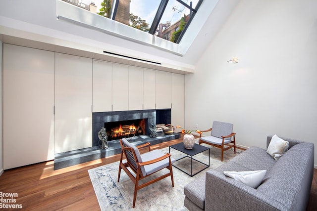 251 E 61st St, New York City, NY 10065 - living area featuring a high ceiling, a tile fireplace, and wood finished floors