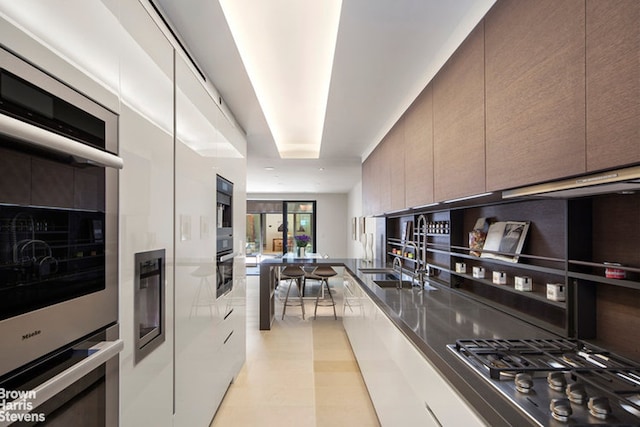 251 E 61st St, New York City, NY 10065 - kitchen with modern cabinets, stainless steel appliances, and a sink