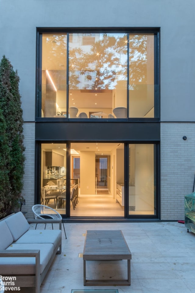 251 E 61st St, New York City, NY 10065 - rear view of house with brick siding and an outdoor hangout area
