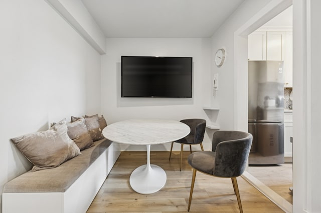 living room with light wood-style flooring and breakfast area