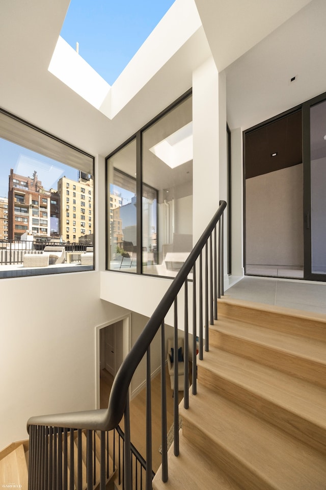 48 W 85th St, New York City, NY 10024 - staircase with wood finished floors and a view of city