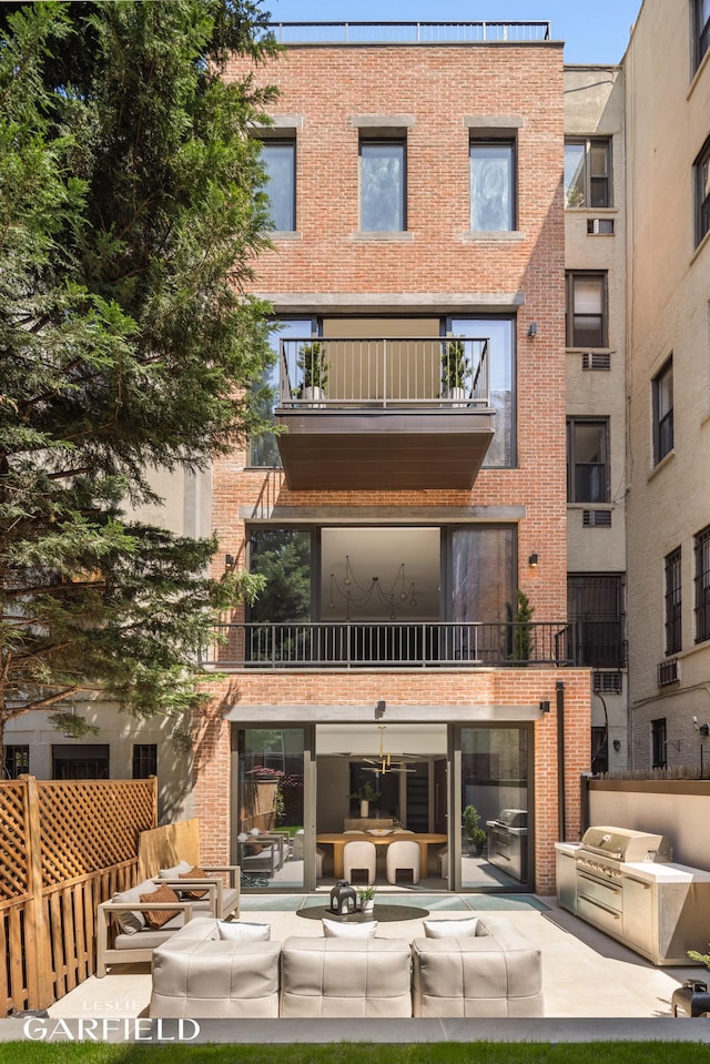48 W 85th St, New York City, NY 10024 - rear view of house with brick siding, area for grilling, a balcony, a patio, and outdoor lounge area