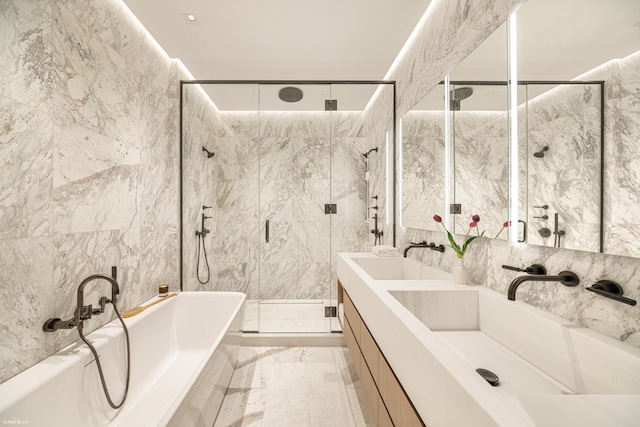 48 W 85th St, New York City, NY 10024 - bathroom with a bathtub, double vanity, tile walls, a stall shower, and marble tiled flooring