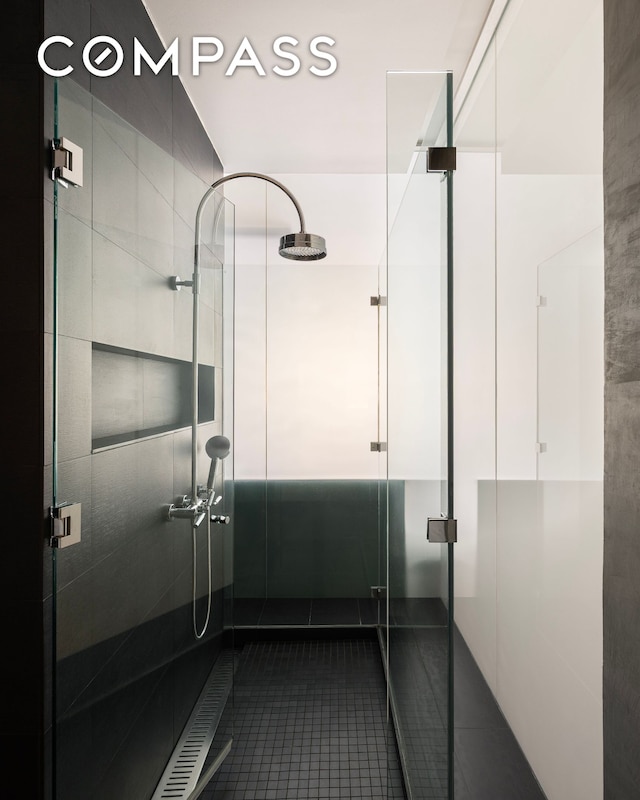 bathroom featuring tile patterned floors and a stall shower