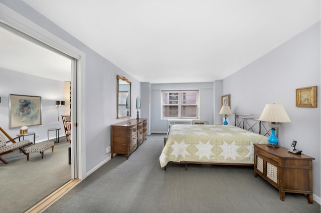 carpeted bedroom featuring baseboards and radiator heating unit
