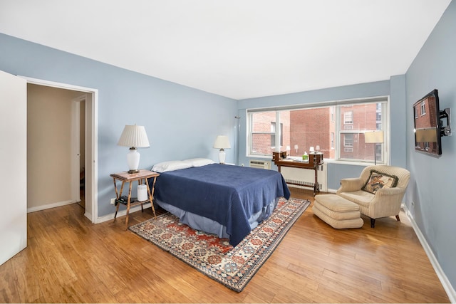 bedroom featuring wood finished floors and baseboards