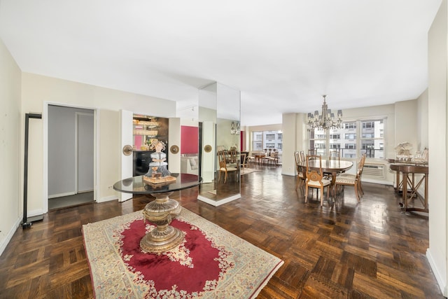 living room featuring a chandelier and baseboards