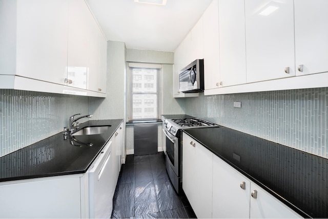 50 Sutton Pl S Unit 8G, New York City, NY 10022 - kitchen with stainless steel appliances, a sink, dark countertops, tasteful backsplash, and white cabinets